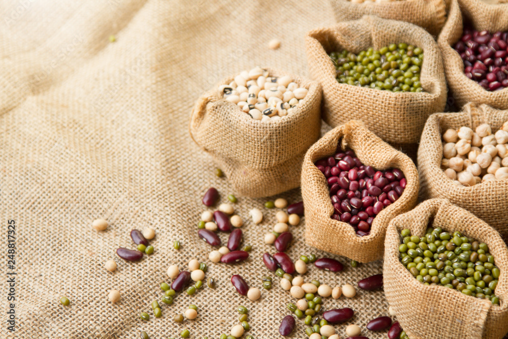 Various of legumes seed in sack bag put on linen fabric background Various of legumes seed in sack bag put on linen fabric background