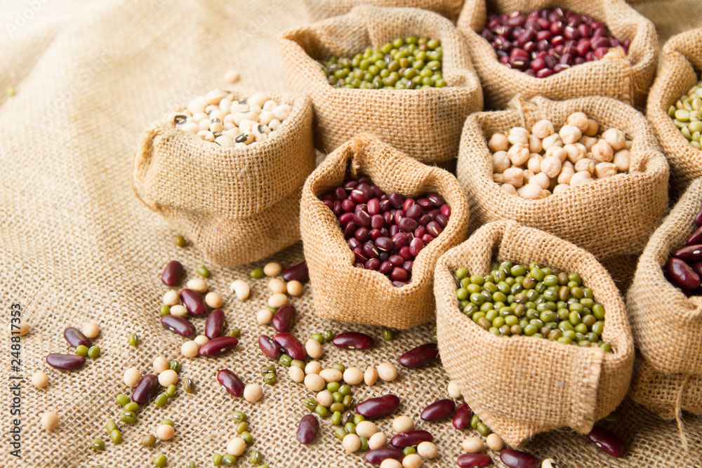 Various of legumes seed in sack bag put on linen fabric background Various of legumes seed in sack bag put on linen fabric background