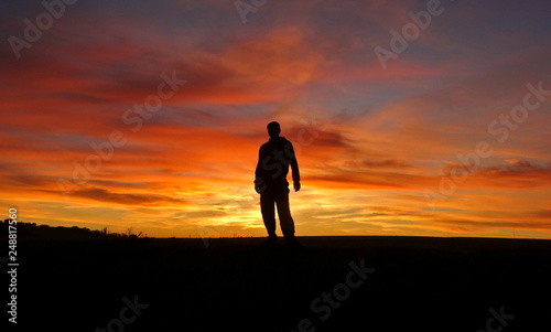 A man on the background of an incredible beautiful sunset.