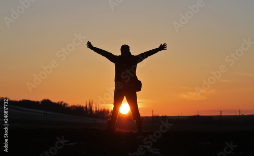 Fototapeta Naklejka Na Ścianę i Meble -  A man on the background of an incredible beautiful sunset.