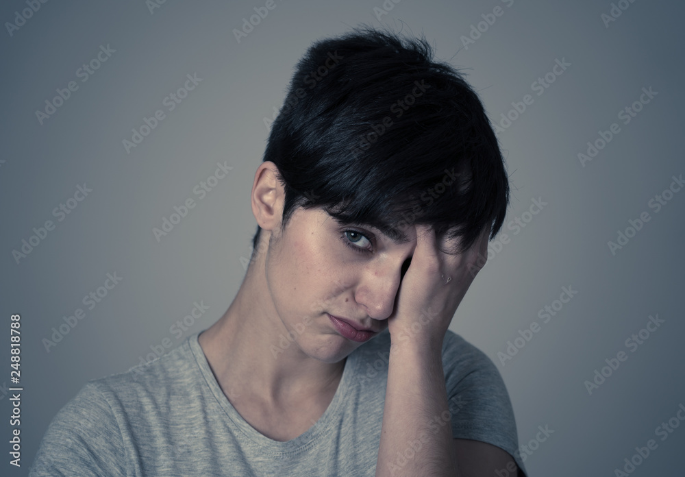 Human expressions and emotions. Young attractive woman with a sad face, looking down hopeless. Human expressions and emotions. Young attractive woman with a sad face, looking down hopeless.