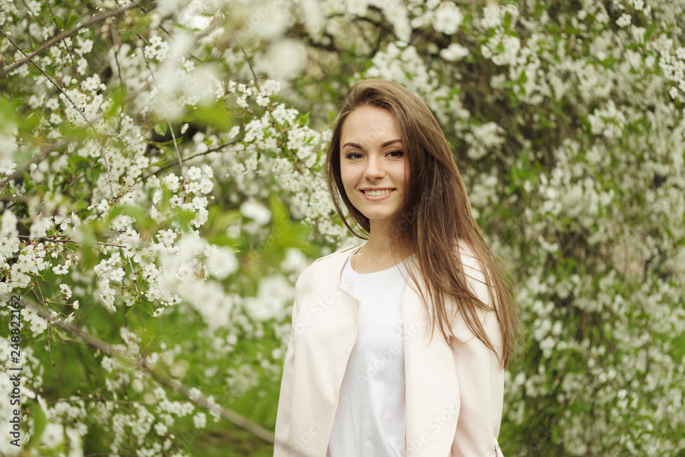 Beautiful brunette girl posing for photo with flowers Beautiful brunette girl posing for photo with flowers