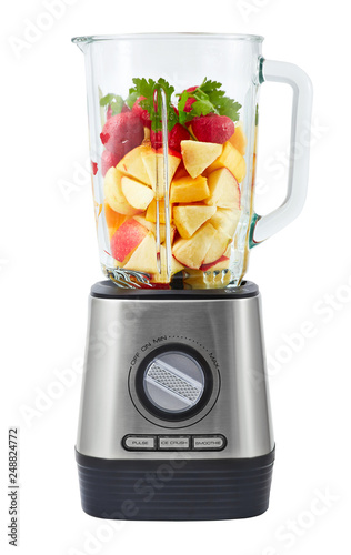 Stationary blender filled with slices of apples, pumpkins, strawberries for making smoothie.