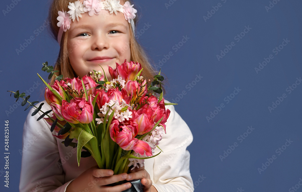 Pretty little girl with bouquet of spring tulips flowers for woman or mothers day 8 march happy smiling Pretty little girl with bouquet of spring tulips flowers for woman or mothers day 8 march happy smiling