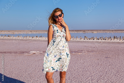 girl on a salty pink lake. © Oleg