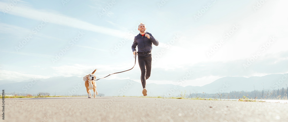 © Soloviova Liudmyla - Running man with his dog . Active healthy lifestyle concept image. © Soloviova Liudmyla - Running man with his dog . Active healthy lifestyle concept image.