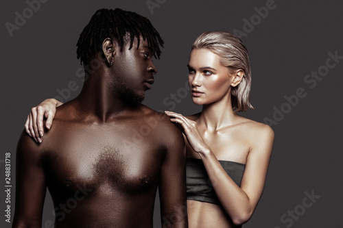 African-American model with dreadlocks looking at his colleague