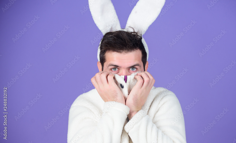 Some bunny loves you. Man wearing rabbit ears. Easter hare. Bearded man in easter rabbit costume. Happy Hipster dressed for Easter party. Celebrating spring, new life and fertility. Spring holiday Some bunny loves you. Man wearing rabbit ears. Easter hare. Bearded man in easter rabbit costume. Happy Hipster dressed for Easter party. Celebrating spring, new life and fertility. Spring holiday