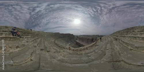 360 VR video. Roman amphitheatre with some tourists expolring it. Ancient Hierapolis city in Pamukkale, Turkey. It was built in the 2nd century AD. UNESCO World Heritage Site photo