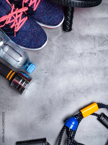 Sports equipment on a grey wooden background. Top view. Motivation