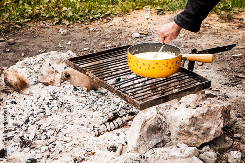 Swiss cheese fondue cooked in an outside firewood. 