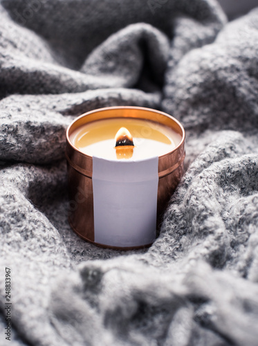 Obraz na plátně Elegant home decoration with wooden wick burning candle and knitted blanket