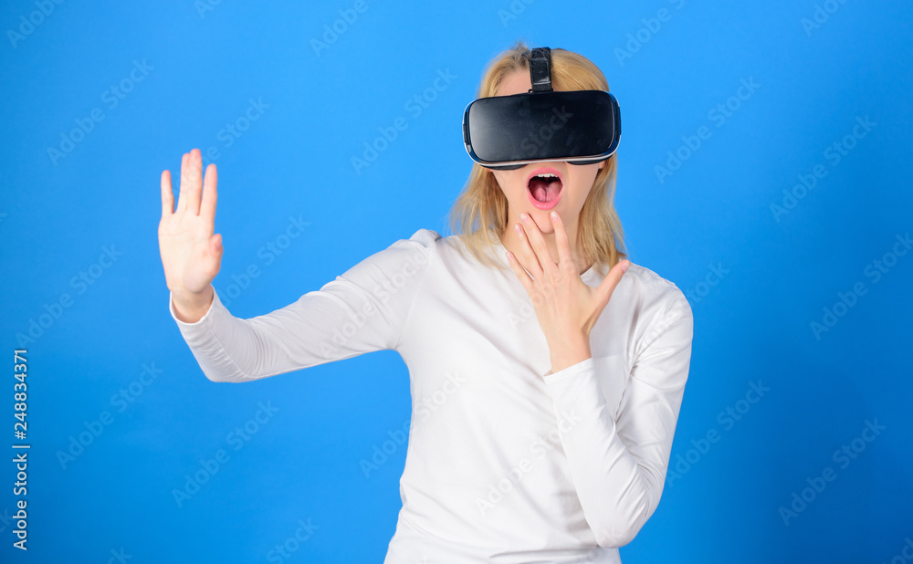 Woman excited using 3d goggles. Woman wearing virtual reality goggles in blue background. Woman using virtual reality headset. Futuristic concept. Woman excited using 3d goggles. Woman wearing virtual reality goggles in blue background. Woman using virtual reality headset. Futuristic concept.