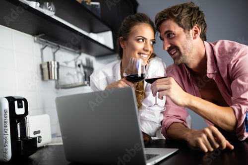 Young couple relaxing at home with laptop. Love,happiness,people and fun concept.