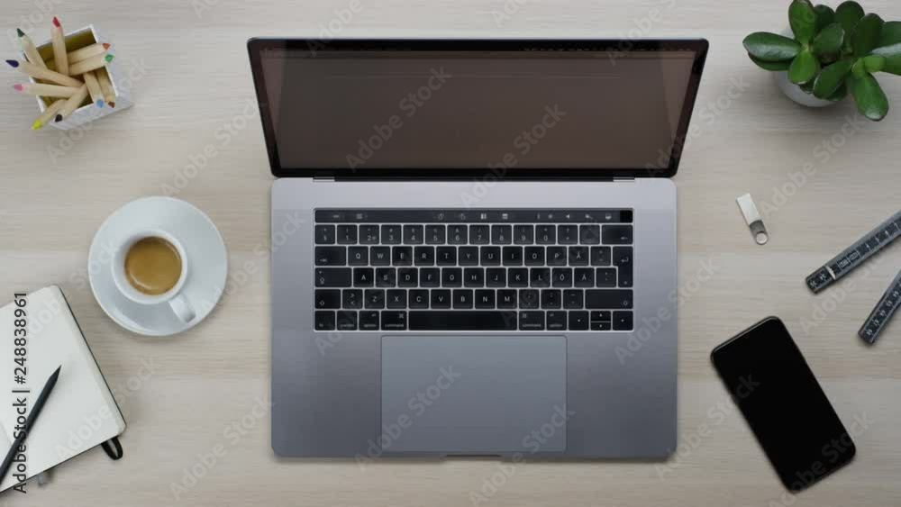 Male hands typing laptop on white clean minimalistic table with top view, gestures and finger movements Male hands typing laptop on white clean minimalistic table with top view, gestures and finger movements