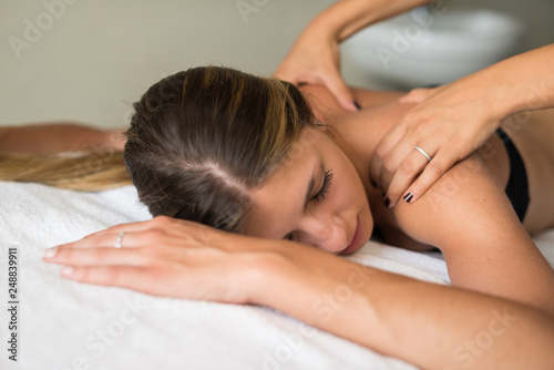 Woman relaxing shoulders massage spa
