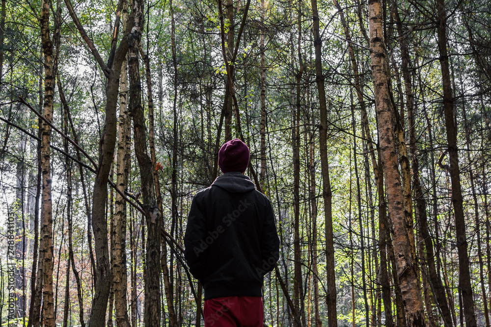 man alone in deep thought in the forest 