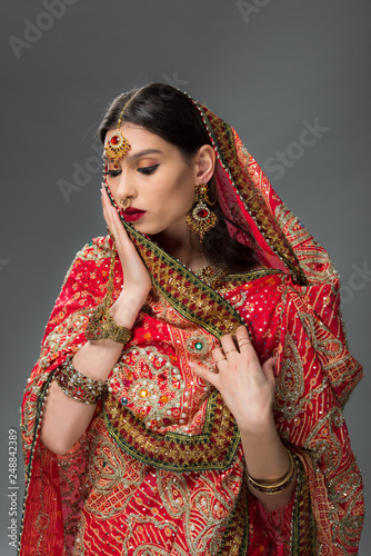 elegant indian woman in traditional sari and bindi, isolated on grey