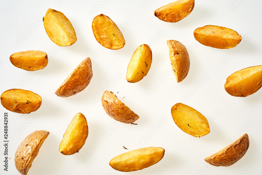 Fresh oven baked potato wedges with their skins Fresh oven baked potato wedges with their skins