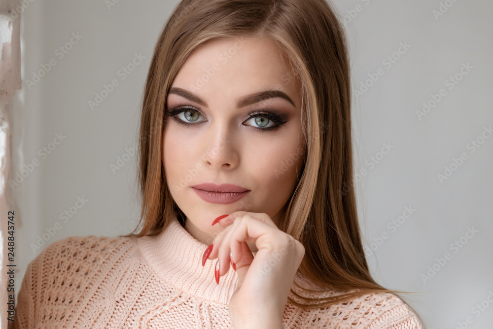 Beautiful girl on white wall background. Shooting in the studio.