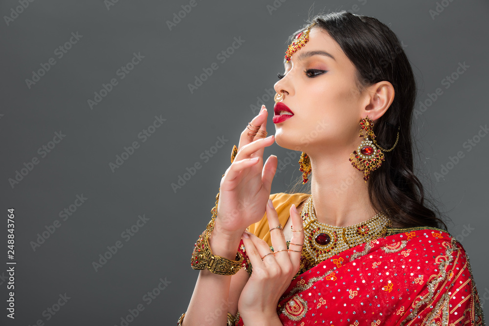 attractive indian woman gesturing in accessories, isolated on grey attractive indian woman gesturing in accessories, isolated on grey