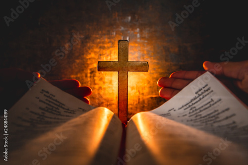 opening bible with cross in...