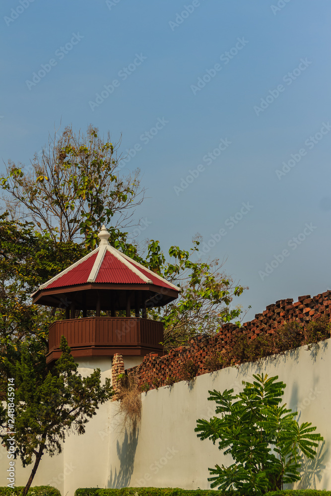Old prison guard tower that constructed with brick, wood and red roof tiles. A watchtower on the corner of a prison wall in Bangkok, Thailand. Old prison guard tower that constructed with brick, wood and red roof tiles. A watchtower on the corner of a prison wall in Bangkok, Thailand.