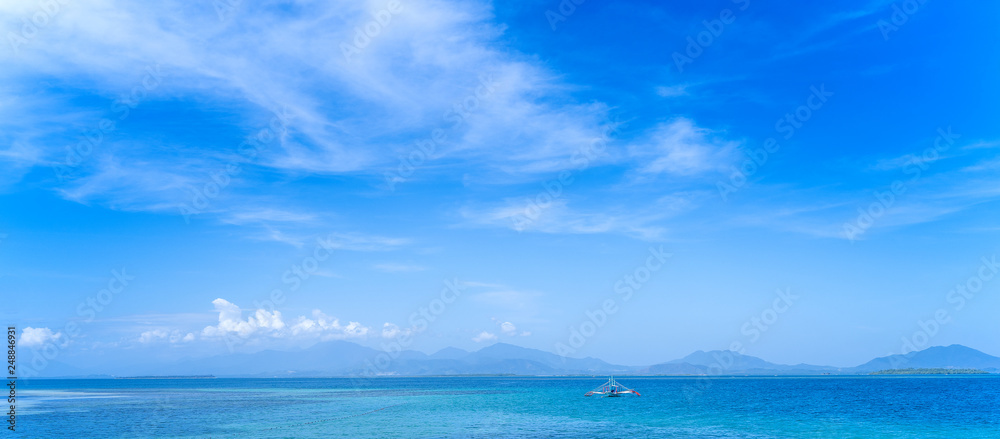 Beautiful ocean scene view isolated with light blue sky background, concept of vacation and sea travel, copy space