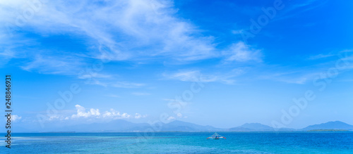 Beautiful ocean scene view isolated with light blue sky background  concept of vacation and sea travel  copy space