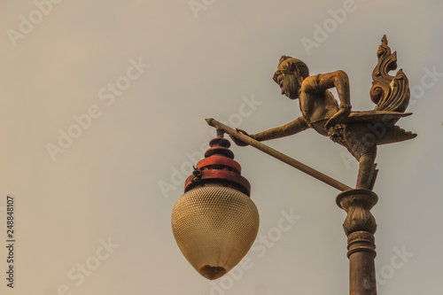 Beautiful Kinnaree lantern lamp on street in blue sky background. photo