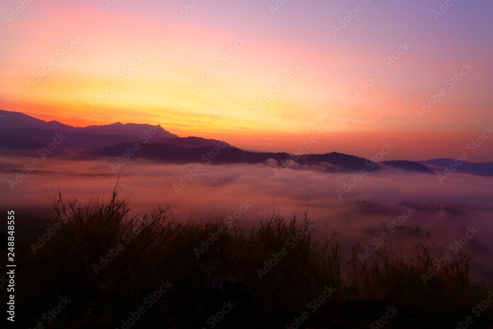 Dramatic sky before the sun rise and misty foreground the mountains landscape