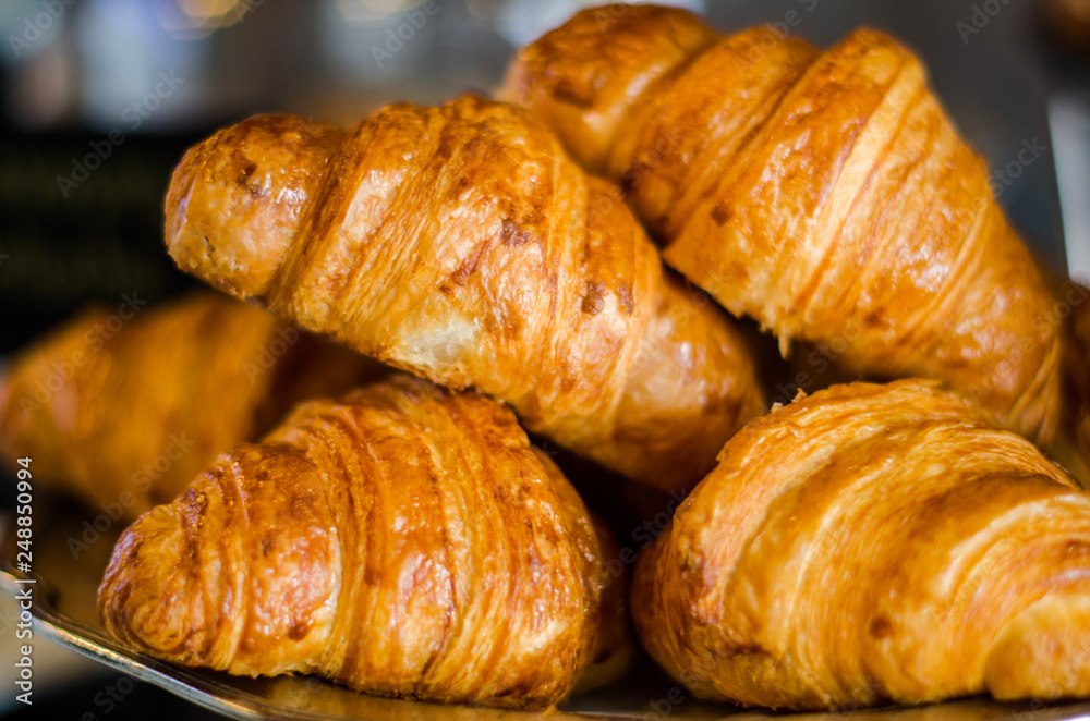 Croissant is a type of bread that is put together on an iron tray.