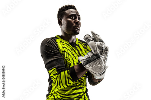 One african male soccer player goalkeeper standing and looking away. Silhouette isolated on white studio background © master1305