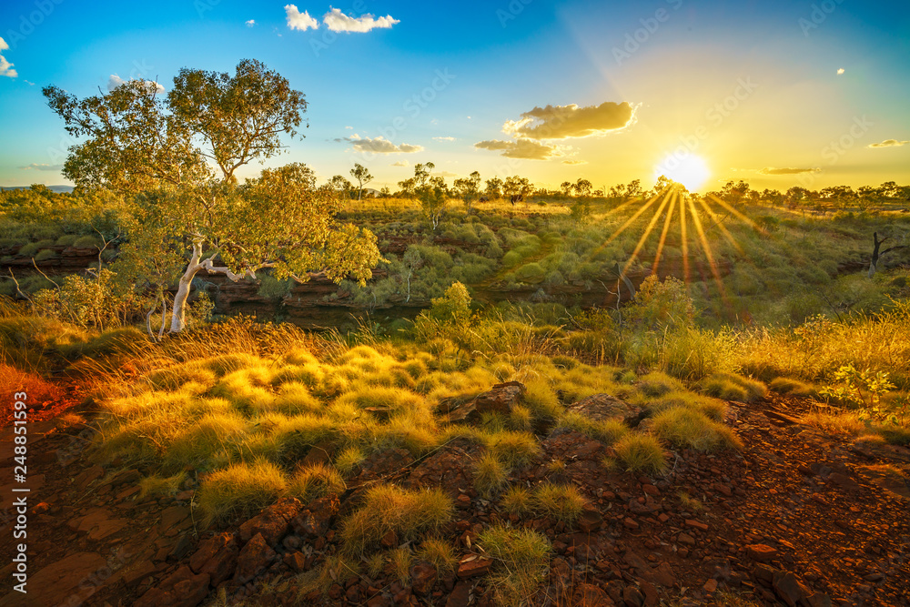 sun at sunset over joffre gorge in karijini national park, western australia 1
