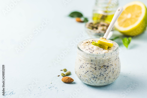 Quadro su tela Lemon poppy seed overnight oats with honey on light blue background
