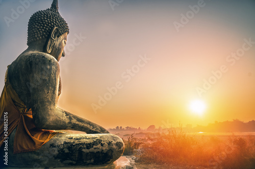 sitting Budha statue facing sunrising