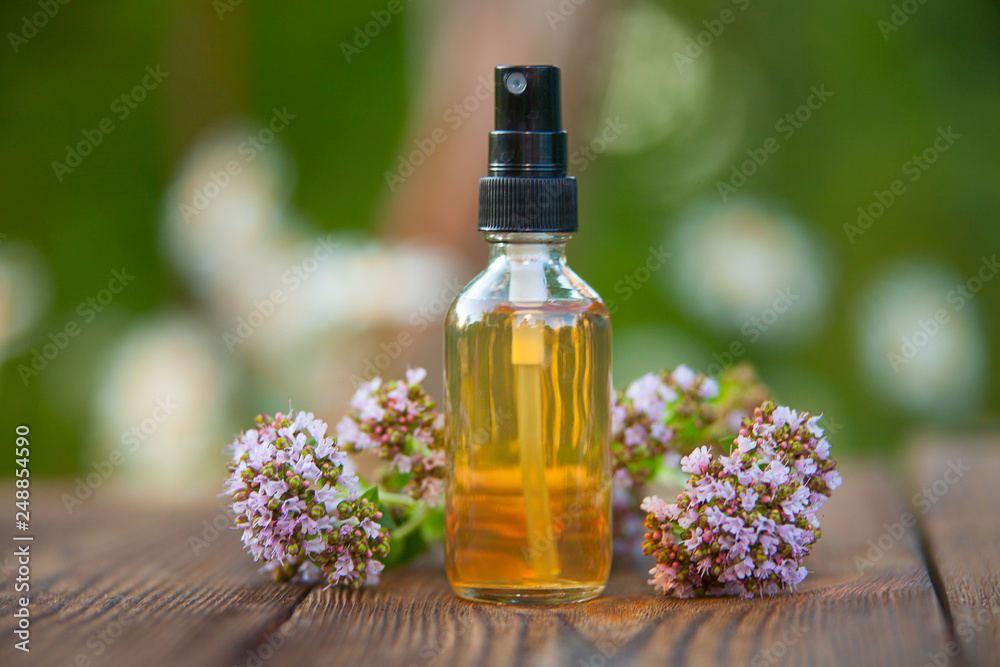 Essence of lavender flowers on table in beautiful glass Bottle Essence of lavender flowers on table in beautiful glass Bottle