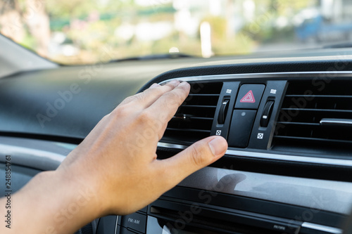 Hand checking the air conditioner in the car, The cooling system in the car
