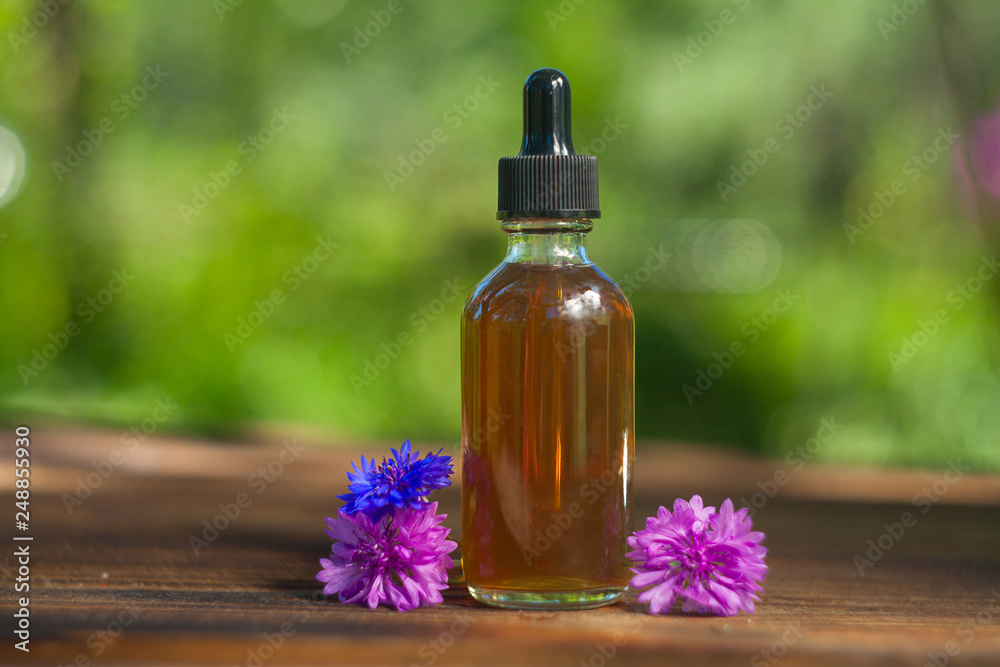 Essence of lavender flowers on table in beautiful glass Bottle Essence of lavender flowers on table in beautiful glass Bottle