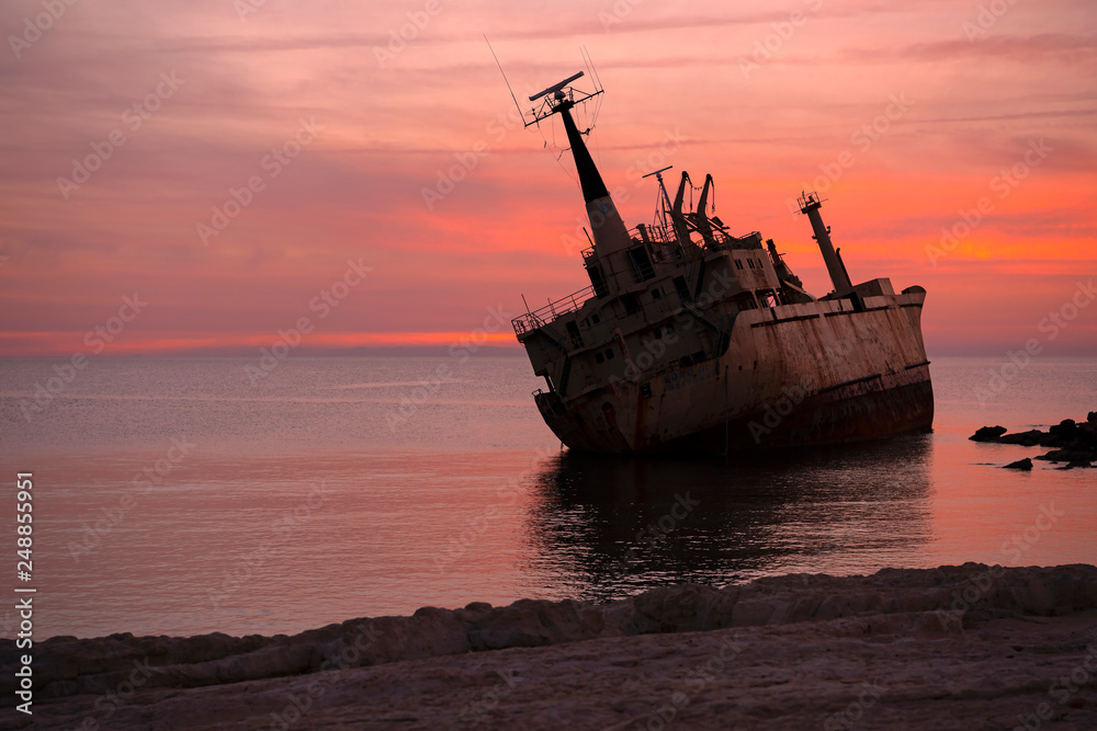 Fototapeta premium Beautiful seascape and shipwreck. Abandoned ship Edro III at sunset near the Paphos, Cyprus.