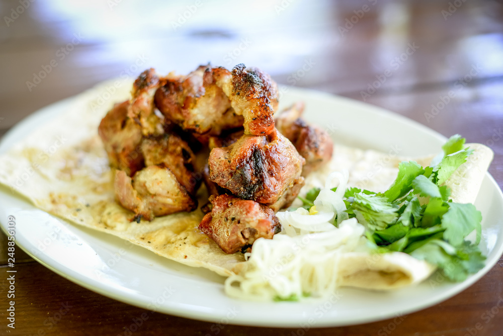 roasted meat on a grill in pita bread, shish kebab, close-up. roasted meat on a grill in pita bread, shish kebab, close-up.