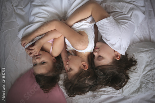 Funny children siblings are sleeping in an embrace