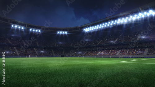 modern football stadium illuminated by floodlights and empty green grass