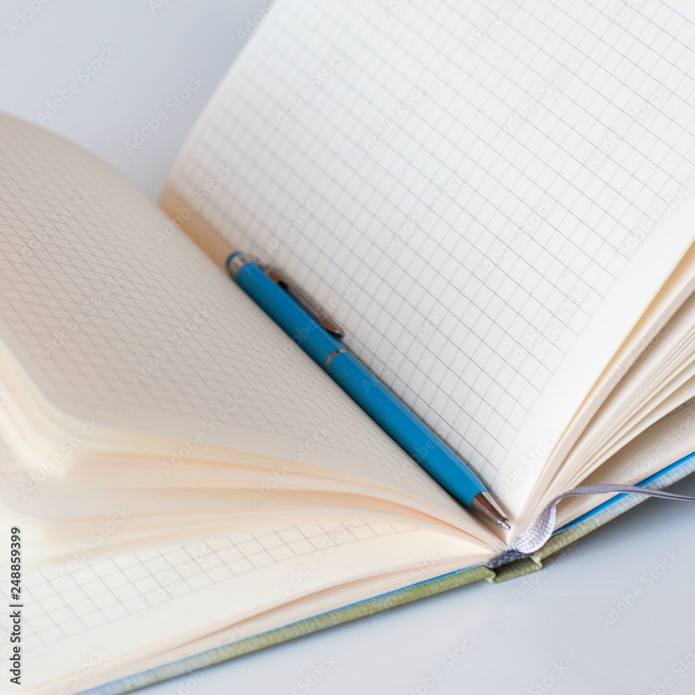 Open a clean notebook in a cage. Diary. Business. Blank paper Open a clean notebook in a cage. Diary. Business. Blank paper