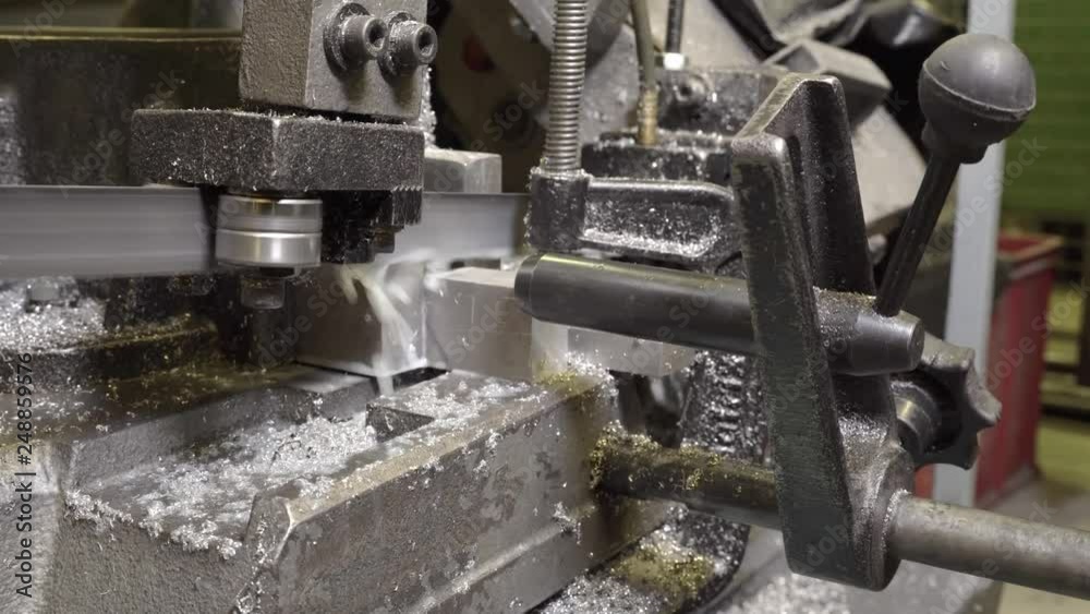 Bandsaw work process at an industrial enterprise close-up. Bandsaw work process at an industrial enterprise close-up.