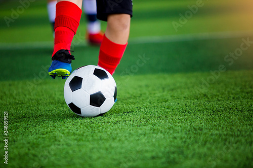 young boy soccer players run to trap and control the ball for shoot to goal