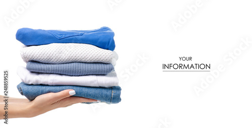 Stack of clothing jeans sweaters in hand pattern on a white background isolation