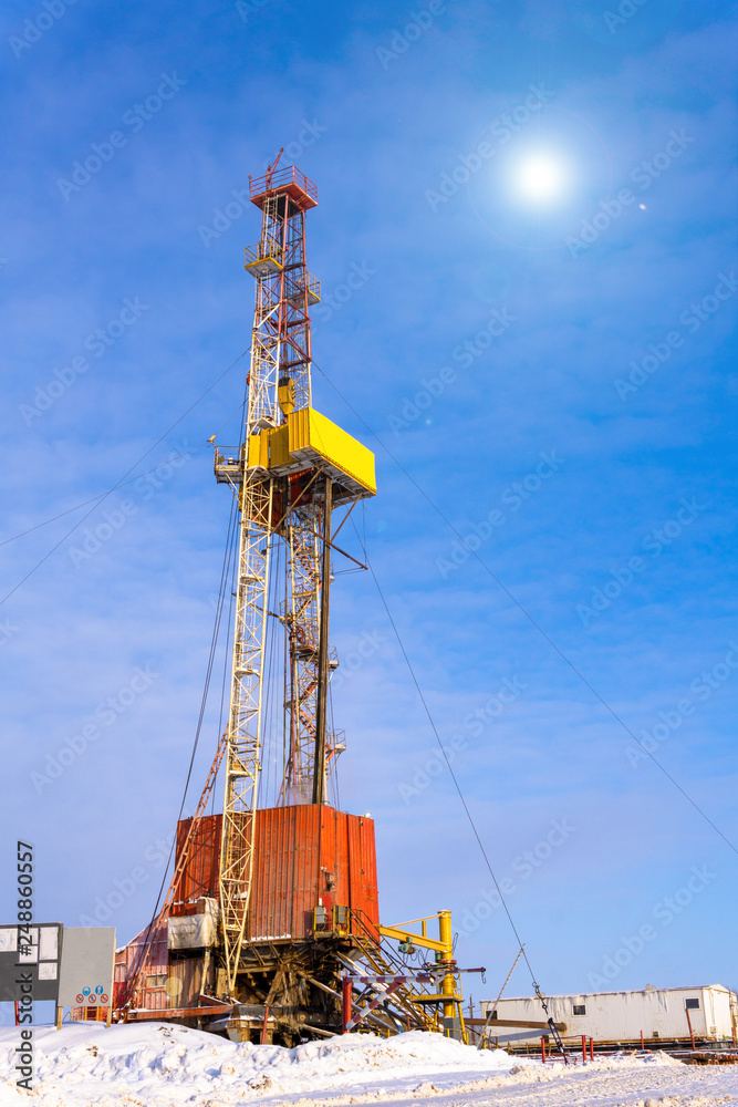 Oil and Gas Drilling Rig onshore dessert with dramatic cloudscape. Oil drilling rig operation on the oil platform in oil and gas industry. Land drilling rig blue sky Oil and Gas Drilling Rig onshore dessert with dramatic cloudscape. Oil drilling rig operation on the oil platform in oil and gas industry. Land drilling rig blue sky