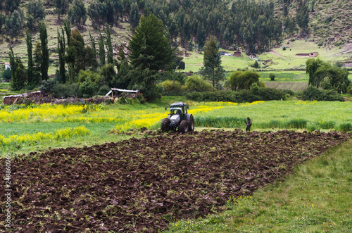 Farmer working in the tractor plow fields, preparing the land for planting.