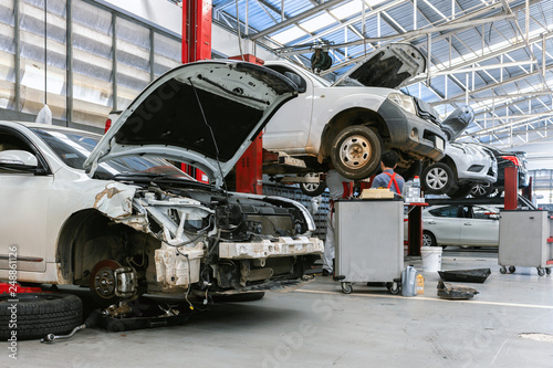 closeup car in repair station and body shop with soft-focus and over light in the background © memorystockphoto